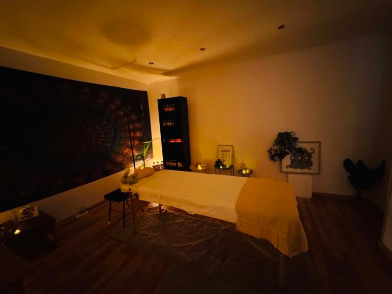 Gyertyafényes ájurvédikus masszázsszoba meleg esti hangulatban — Chandra Ayurveda Budapest, Újbuda